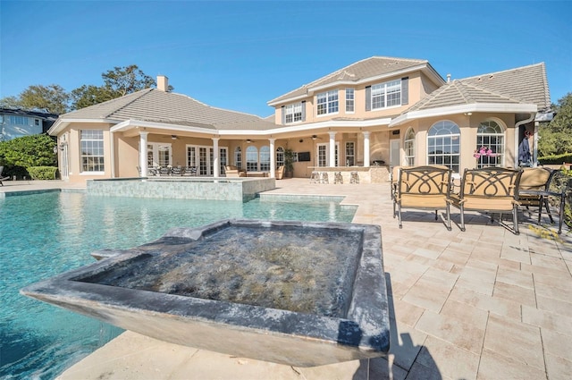 view of pool featuring a patio area, french doors, ceiling fan, and an in ground hot tub