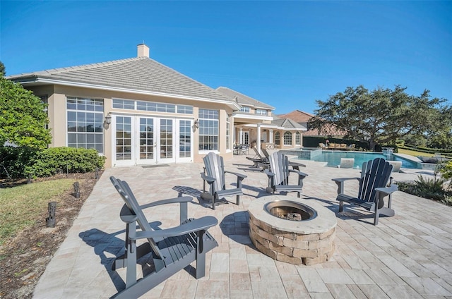 view of patio / terrace featuring french doors and an outdoor fire pit