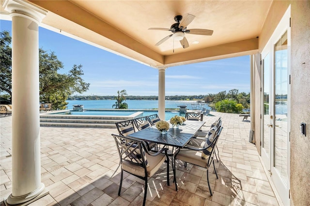 view of patio featuring a water view and ceiling fan