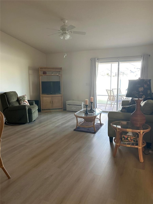 living room with hardwood / wood-style flooring and ceiling fan