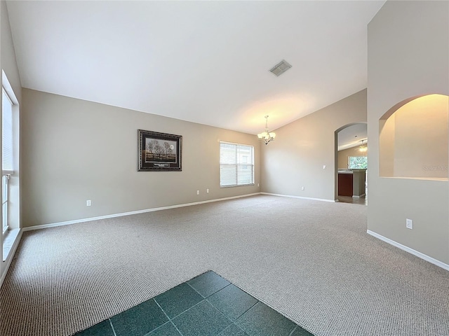 unfurnished room with lofted ceiling, carpet floors, and a notable chandelier