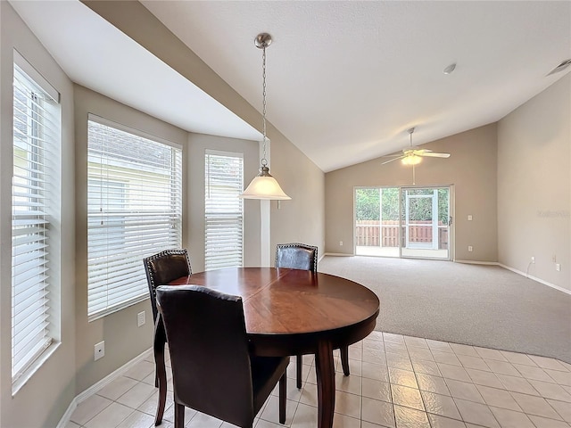 dining area with light carpet, vaulted ceiling, ceiling fan, and a healthy amount of sunlight