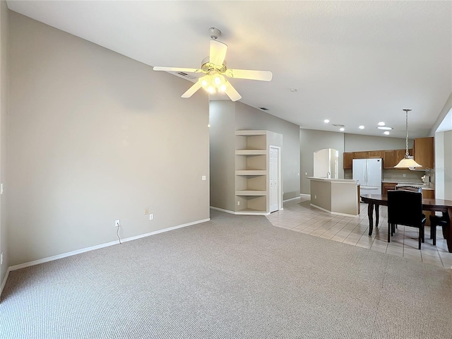 living room with ceiling fan, built in features, light tile patterned floors, and lofted ceiling