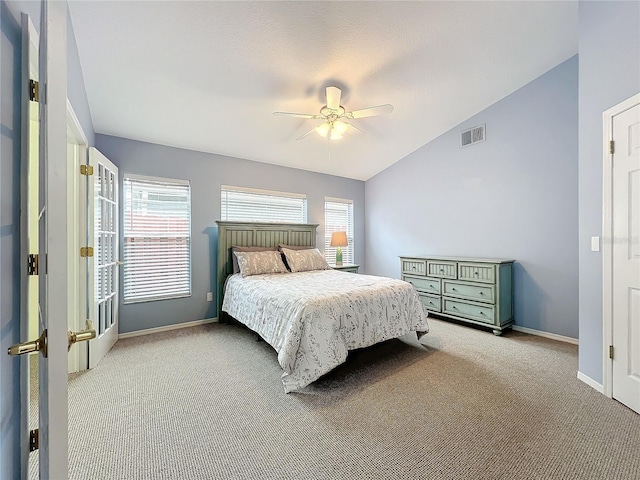 bedroom with ceiling fan, lofted ceiling, light carpet, and multiple windows