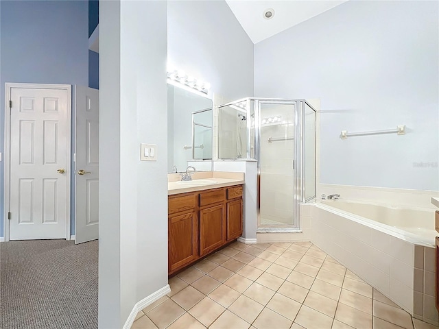 bathroom with tile patterned flooring, shower with separate bathtub, vanity, and high vaulted ceiling