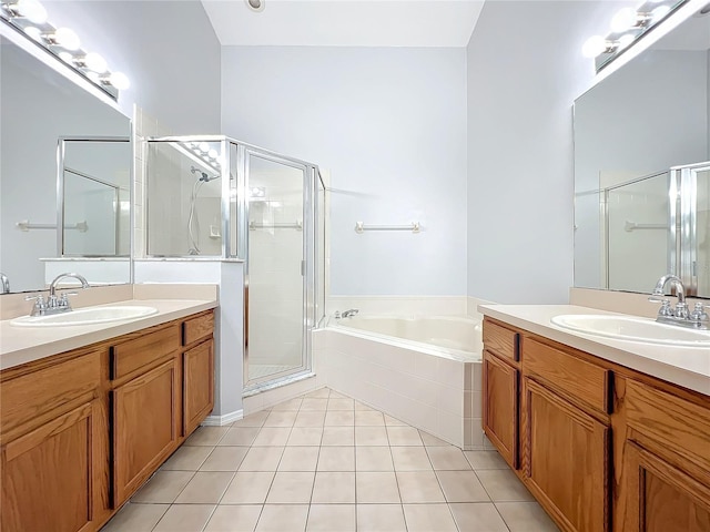 bathroom featuring tile patterned floors, vanity, and shower with separate bathtub