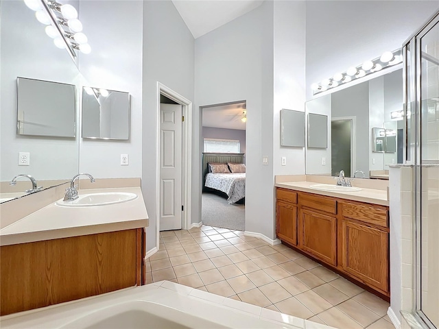 bathroom featuring tile patterned floors, vanity, ceiling fan, and high vaulted ceiling