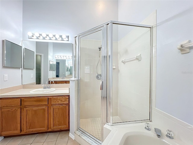 bathroom featuring tile patterned flooring, vanity, and shower with separate bathtub