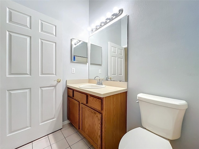 bathroom featuring tile patterned floors, vanity, and toilet