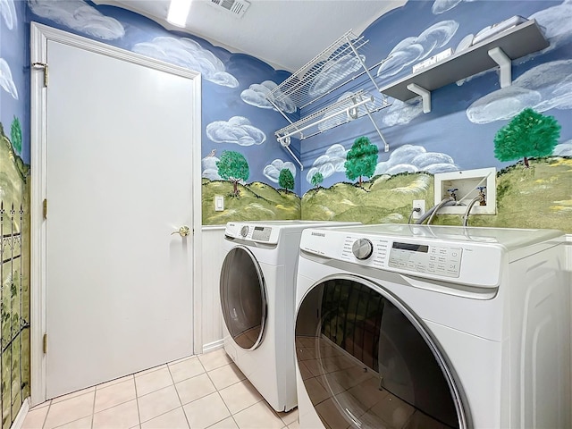 laundry area featuring independent washer and dryer and light tile patterned floors