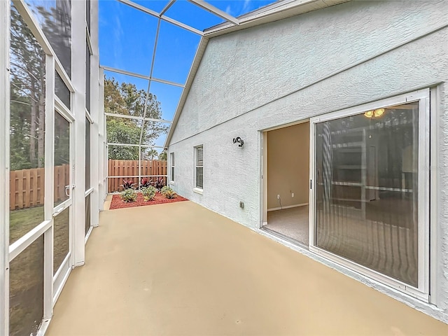 unfurnished sunroom with lofted ceiling