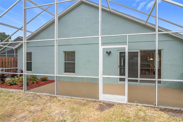 back of property featuring a lanai