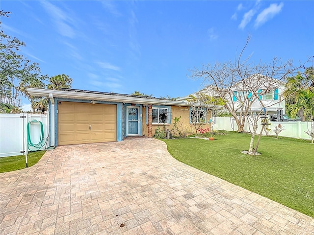 ranch-style house with a front yard, solar panels, and a garage