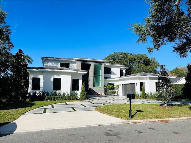 view of front facade featuring a front yard and a garage