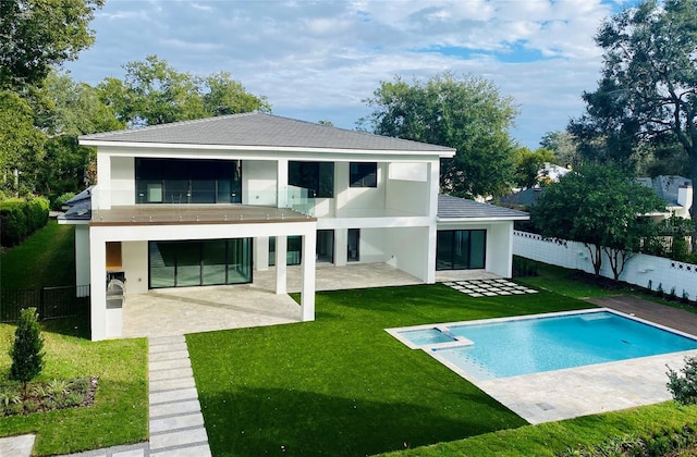 back of house featuring a yard, a patio, and a fenced in pool