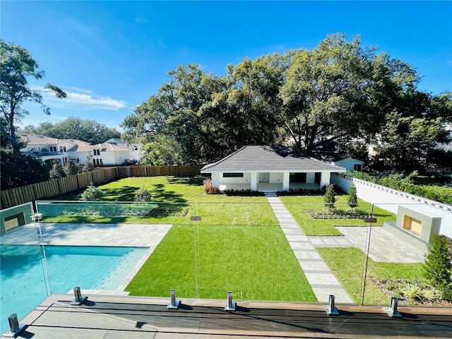 view of swimming pool with a lawn and an outdoor structure