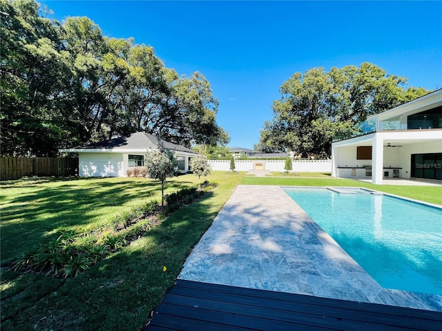 view of pool featuring a lawn, a patio area, and ceiling fan