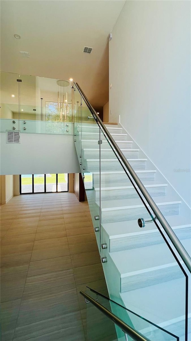 stairway with tile patterned floors