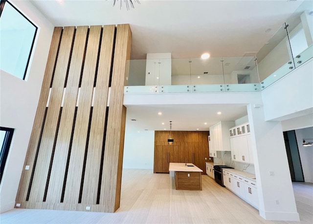 interior space featuring a towering ceiling and wood walls