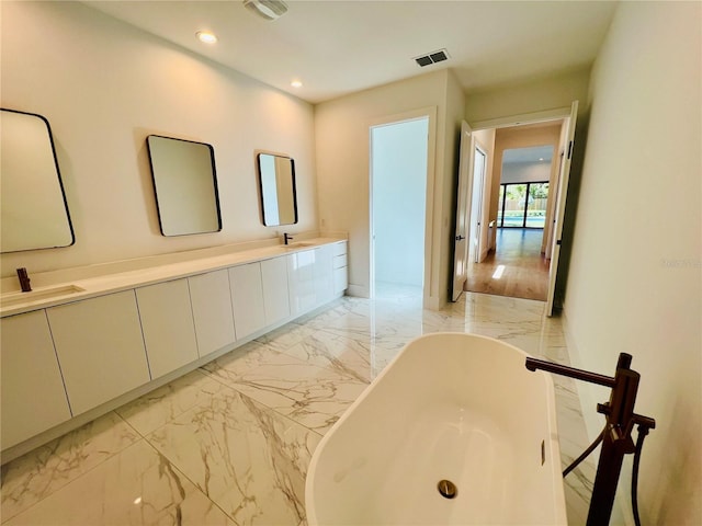 interior space with a bathing tub and vanity