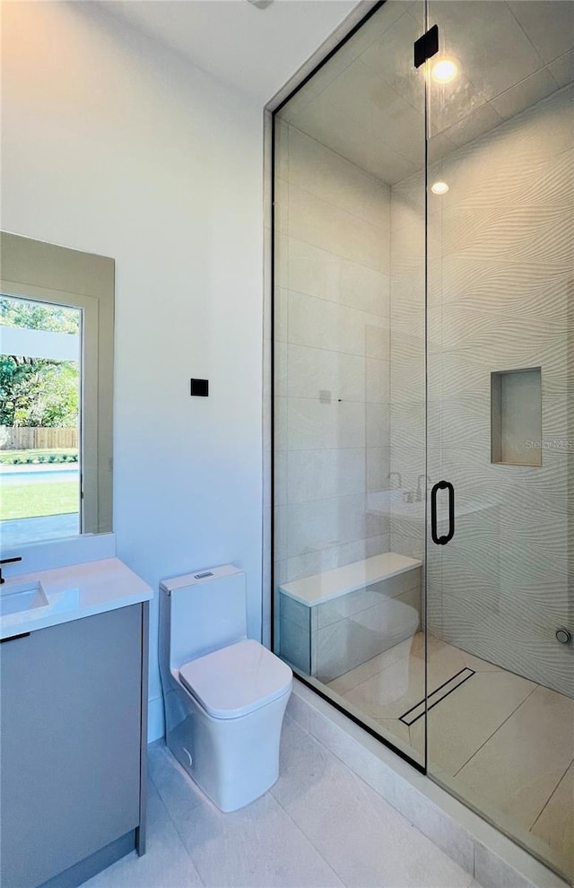 bathroom featuring tile patterned flooring, toilet, an enclosed shower, and vanity