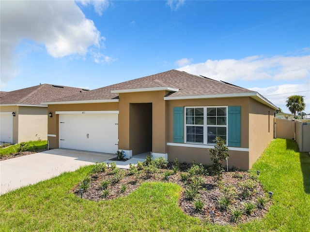 view of front of property with a front yard and a garage