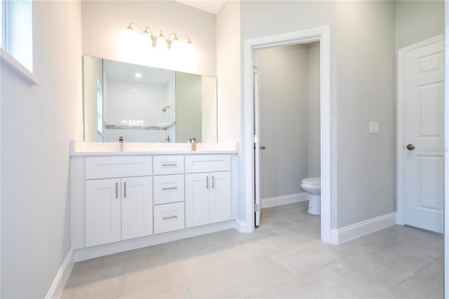 bathroom featuring tile patterned floors, vanity, toilet, and walk in shower