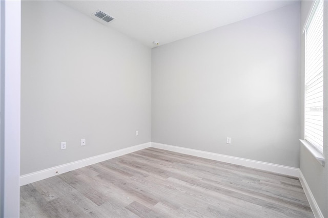 empty room with light hardwood / wood-style flooring