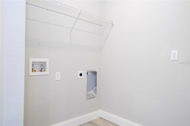 washroom with electric dryer hookup, hookup for a washing machine, and hardwood / wood-style flooring