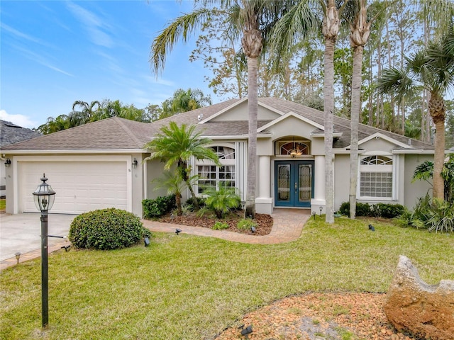 ranch-style home featuring a front lawn, a garage, and french doors