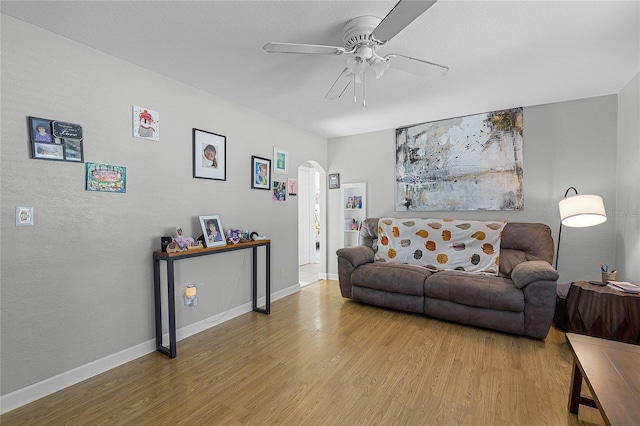 living room with hardwood / wood-style floors and ceiling fan