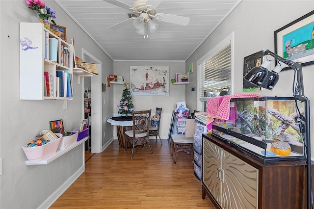 office space featuring ceiling fan, wooden ceiling, light hardwood / wood-style floors, and ornamental molding