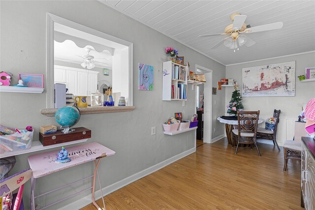 game room with ceiling fan, light hardwood / wood-style floors, wooden ceiling, and crown molding