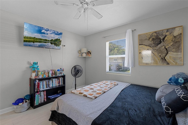 bedroom with ceiling fan and light hardwood / wood-style floors