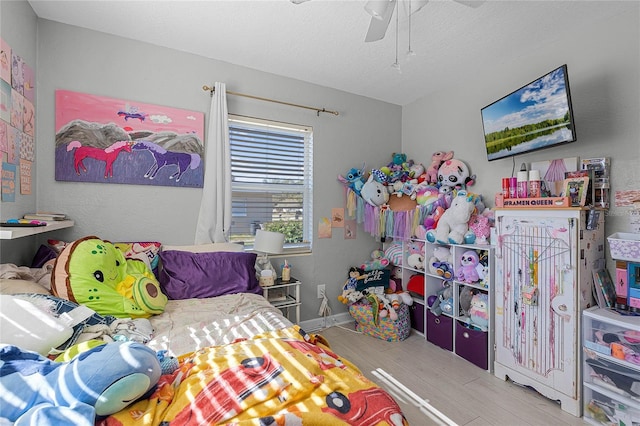 bedroom with ceiling fan and light wood-type flooring