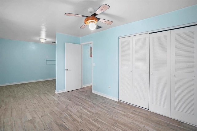 unfurnished bedroom with ceiling fan, a closet, and light hardwood / wood-style floors