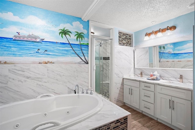 bathroom with hardwood / wood-style floors, vanity, a textured ceiling, and plus walk in shower