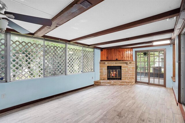 unfurnished living room featuring ceiling fan, light hardwood / wood-style flooring, and beamed ceiling