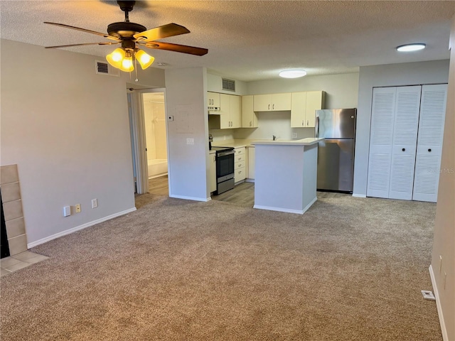 kitchen with light carpet, visible vents, stainless steel appliances, and a center island