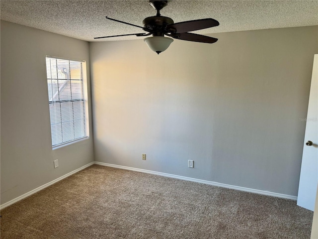 spare room with carpet, baseboards, ceiling fan, and a textured ceiling