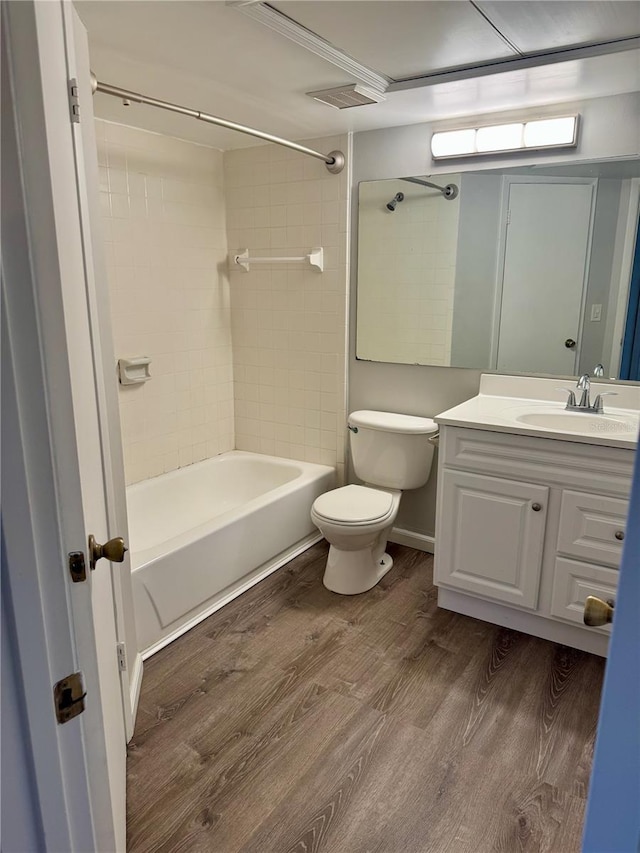 full bath with shower / bath combination, vanity, toilet, and wood finished floors