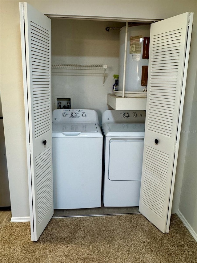 washroom featuring laundry area, baseboards, washer and dryer, and carpet flooring