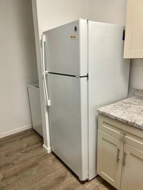315 Lakepointe Dr Unit 302, Altamonte Springs, FL 32701 - kitchen with freestanding refrigerator, light wood-type flooring, and light stone countertops