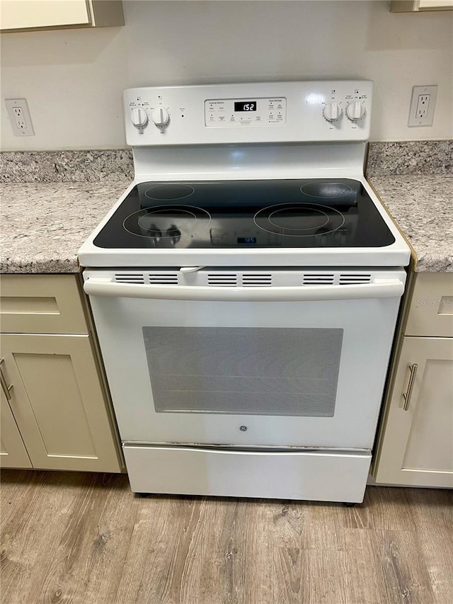 315 Lakepointe Dr Unit 302, Altamonte Springs, FL 32701 - kitchen view of white electric stove and light wood-style flooring