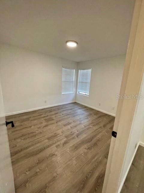 spare room with dark wood-type flooring