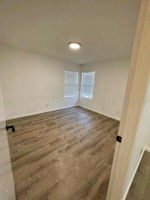 315 Lakepointe Dr Unit 302, Altamonte Springs, FL 32701 - unfurnished room featuring dark wood-type flooring and baseboards