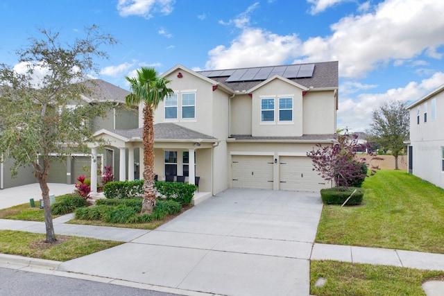 view of front of property featuring a front yard, solar panels, and a garage