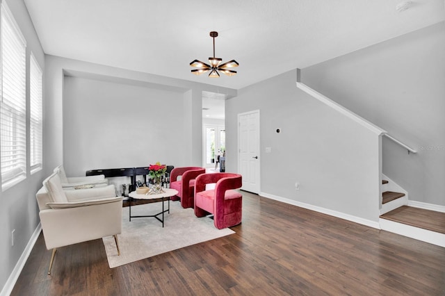 living room featuring french doors, dark hardwood / wood-style floors, a healthy amount of sunlight, and a notable chandelier