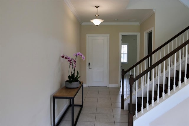 foyer featuring crown molding and light tile patterned flooring