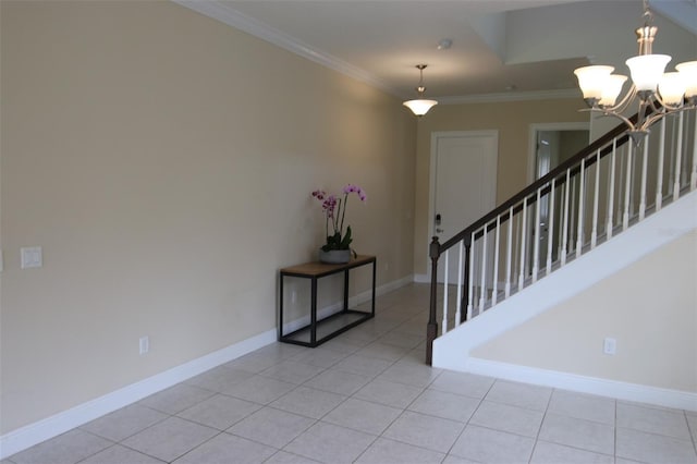 foyer entrance featuring light tile patterned flooring, ornamental molding, and a chandelier